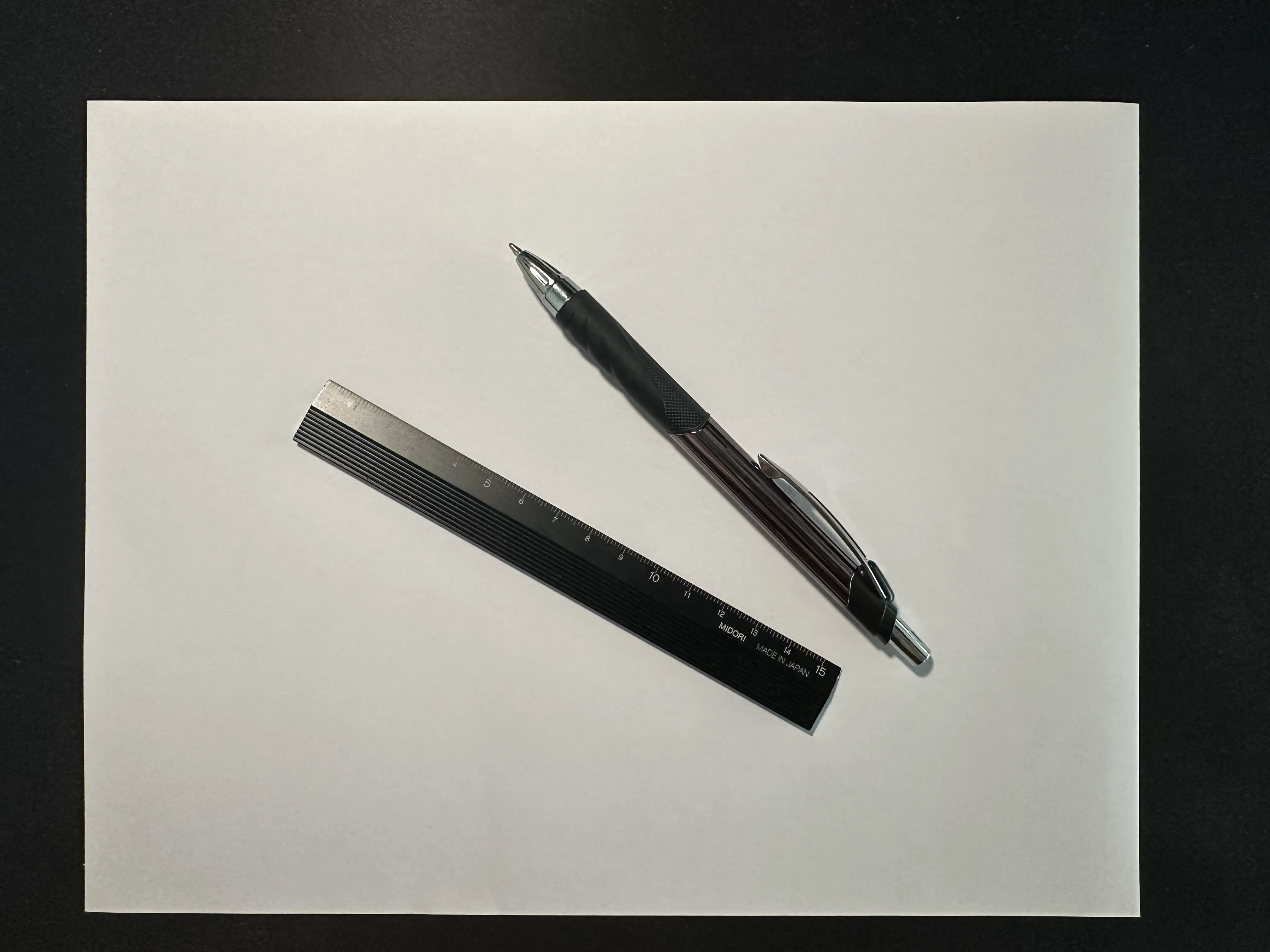 Blank paper, ruler, and pen for drawing over a survey
